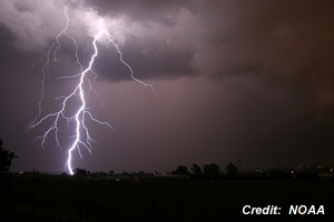 Lightning strike over a town (NOAA)